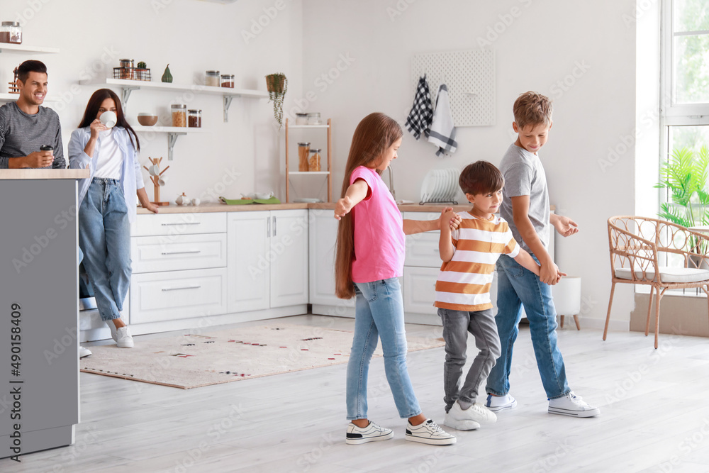 Fototapeta premium Happy family dancing in kitchen