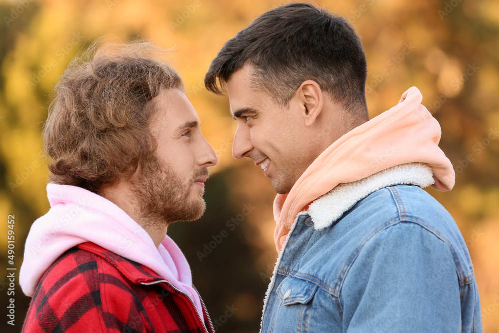 Happy gay couple outdoors on autumn day Happy gay couple outdoors on autumn day