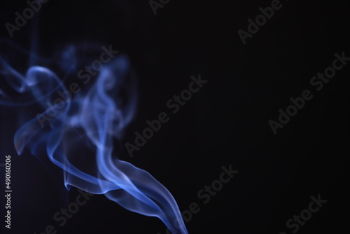 SMOKE IN LIGHT. SMOG ON BLACK BACKGROUND