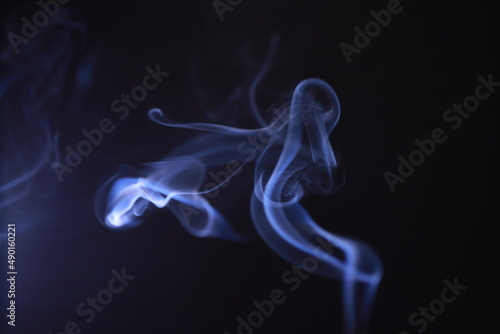 Fototapeta Naklejka Na Ścianę i Meble -  SMOKE IN LIGHT. SMOG ON BLACK BACKGROUND