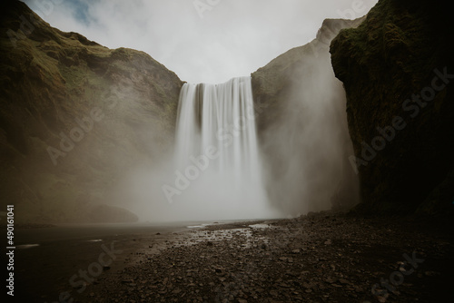 Natural view of the Skougafoss waterfall in Iceland under a gloomy sky