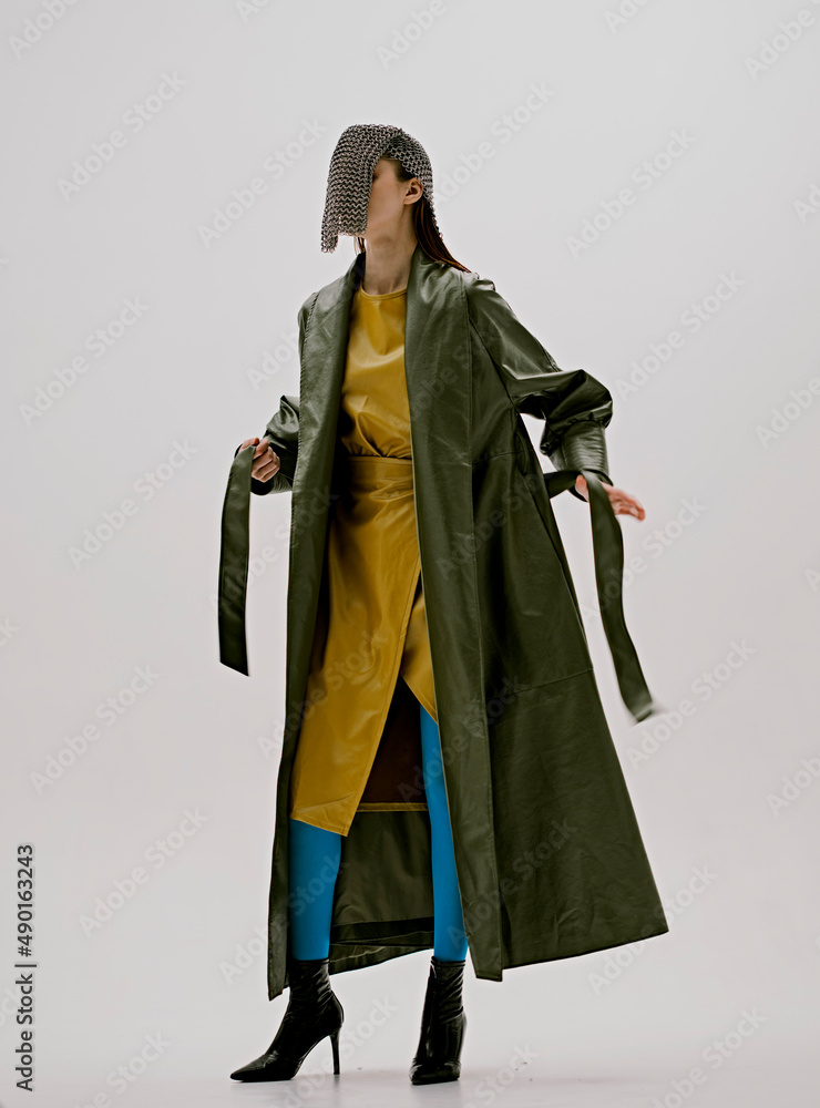 beautiful woman chain mail on the face leather green coat luxury isolated background beautiful woman chain mail on the face leather green coat luxury isolated background