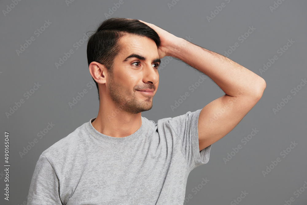 handsome man posing lifestyle gesture with hands Gray background handsome man posing lifestyle gesture with hands Gray background