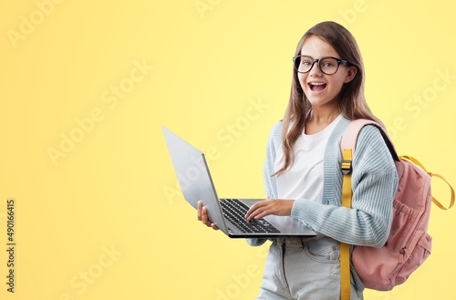 E-Learning. Happy School Girl Using Digital Tablet Doing Homework Online photo