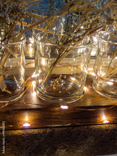 fairy lights lighting up glasses on a wooden stand