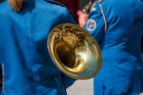 Musical orchestra dressed in blue costumes and white hats photo