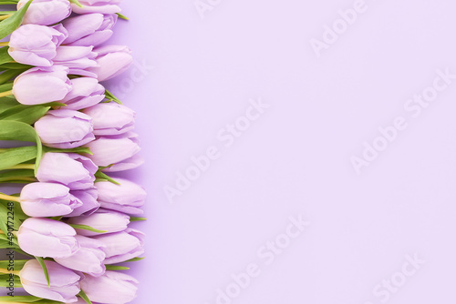 Bouquet of lilac tulips on a lilac background. Mothers Day, Valentines Day, birthday concept