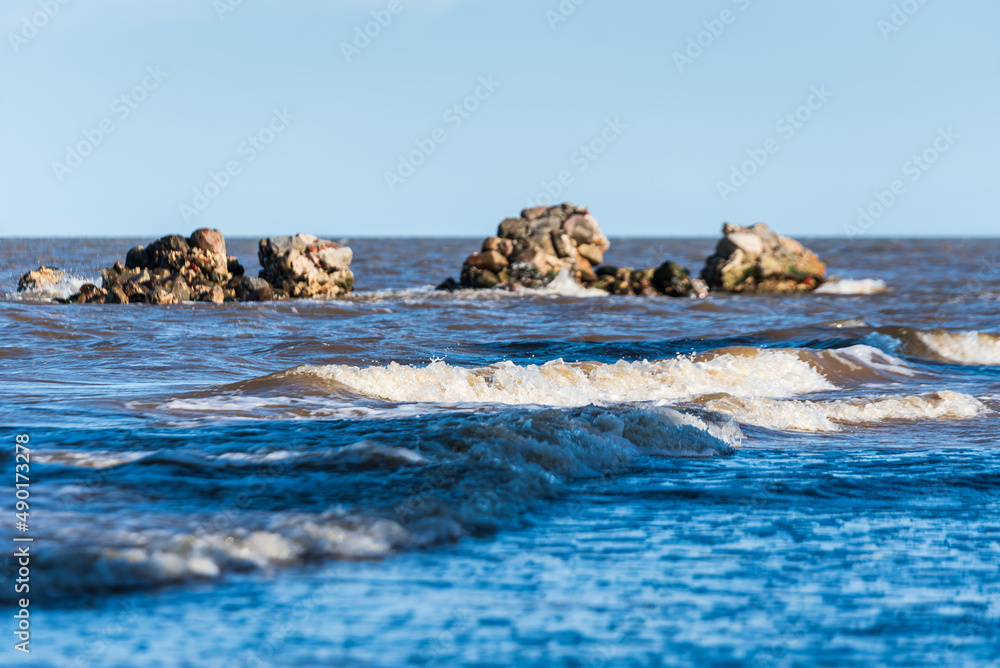 Cape Kolka with stones in water and Baltic sea, Kolka, Latvia.