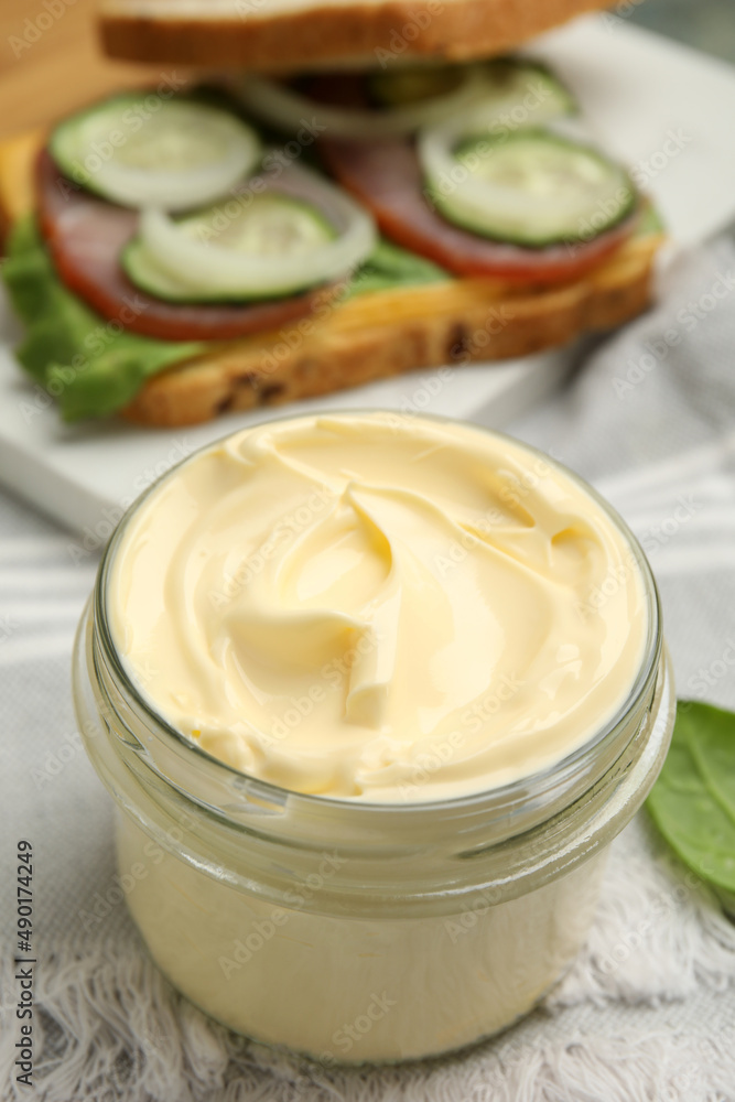 Jar of delicious mayonnaise on table, closeup Jar of delicious mayonnaise on table, closeup