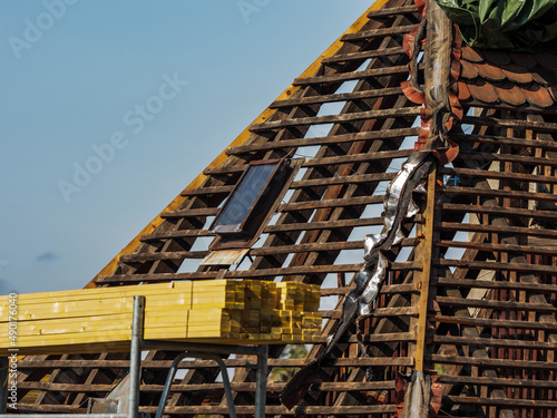 Roof repair in an old house. New beams and new shingles for the old roof.