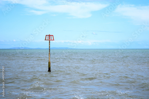 Amroth Beach Navigation Marker with blue sky on the background photo