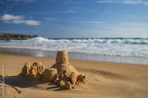 Sandcastle on a sunny beach photo