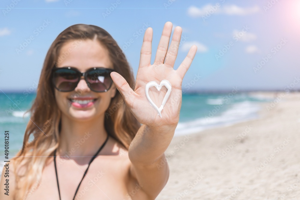 Beautiful woman with sun protection cream at beach Beautiful woman with sun protection cream at beach