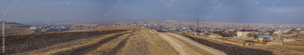 A well-trodden road near the village. Panoramic view of the village. A well-trodden road near the village. Panoramic view of the village.