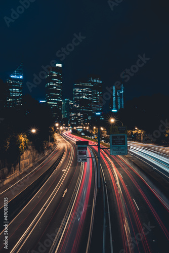 Long exposure of a road to a big city in Sidney at night, Australia © Karl Alder/Wirestock