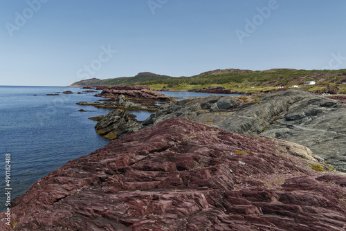 Beautiful view of Red shale rock in a sea in Newfoundland and Labrador coastline, Canada photo