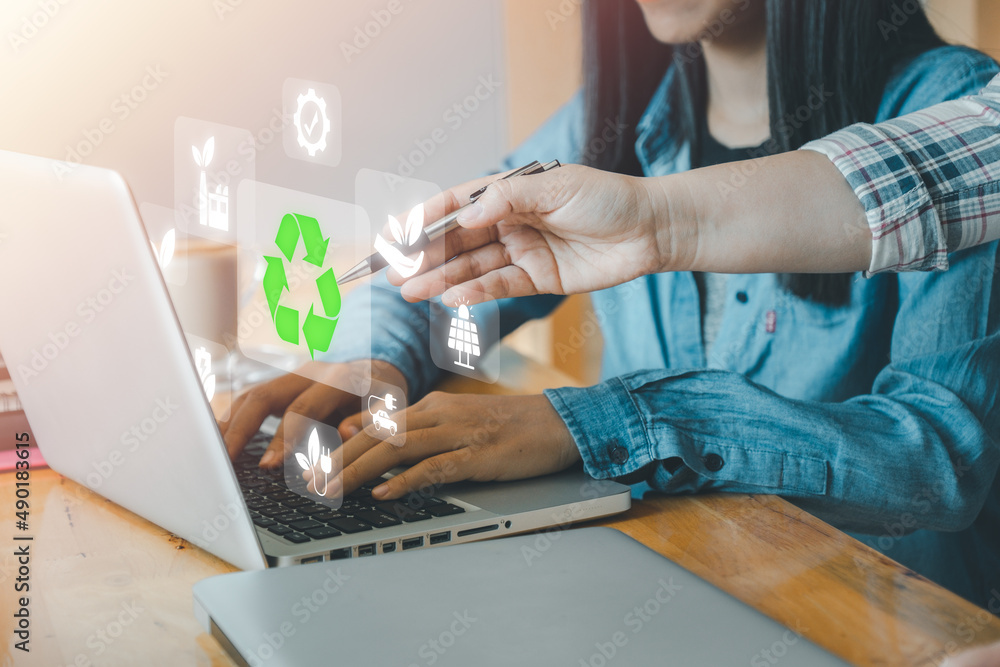 Fototapeta premium ESG concept of environmental, Green ethical business preserving resources, reducing CO2, Caring for employees, Business person team working on laptop computer with VR screen ESG icon.