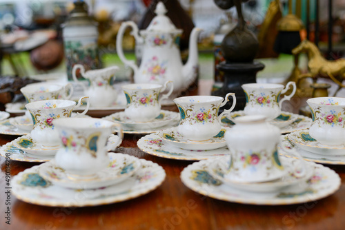 фотографія Closeup of a beautiful flower-ornated tea-set on a wooden table