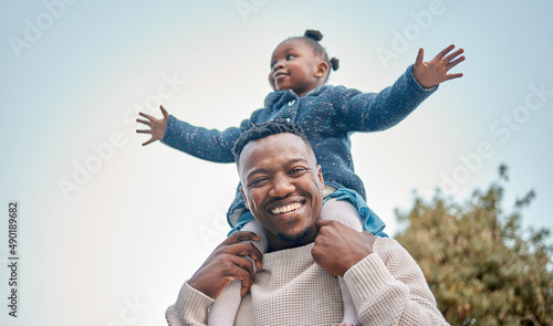 Shes always going to be my little princess. Portrait of a father carrying his daughter on his shoulders outdoors.