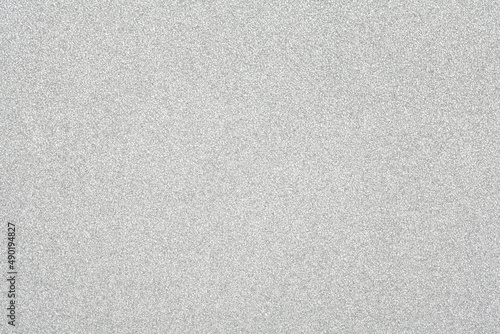 Horizontal silver glitter close up, card stock texture background.