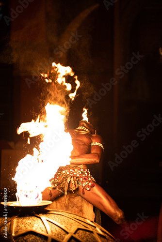 Photography Back shot of a performer Moroccan fire breather, in Marrakech at night
