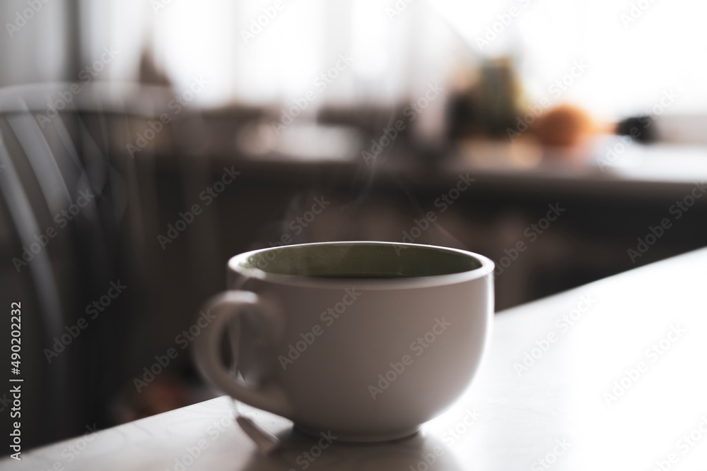 cup of hot drink on the table with aromatic steam cup of hot drink on the table with aromatic steam