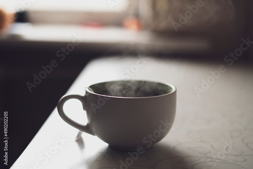 cup of hot drink on the table with aromatic steam