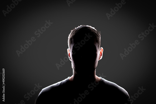 Photography dark backlight shadow silhouette of male person, incognito unknown profile