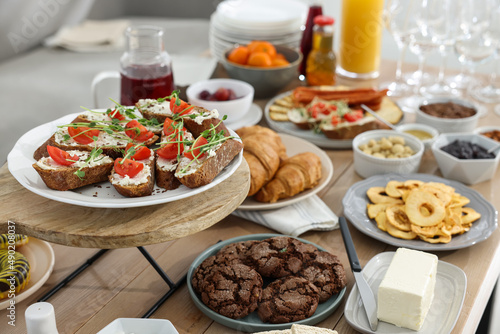 Brunch table setting with different delicious food indoors