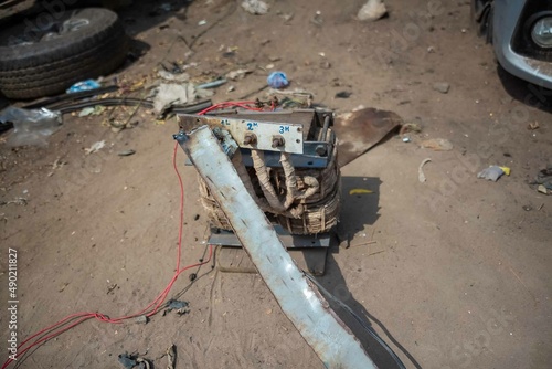 African Auto Bodyworks,  Welding a Car in Africa,  2 African men working on a car, African American auto mechanic at work, African American working with electrodes photo