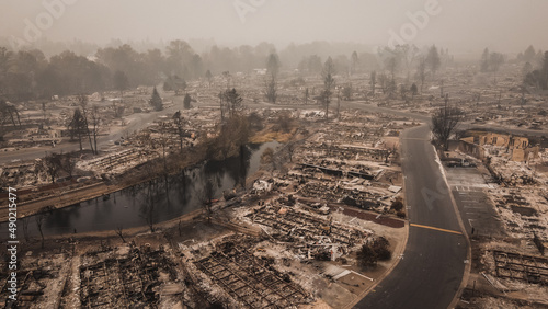 Smoke filled skies overlooking the aftermath and tragedy of a wildfire that blew through small town photo