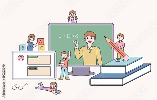 A teacher is teaching a class on a large monitor. Cute students are studying around the monitor. flat design style vector illustration.