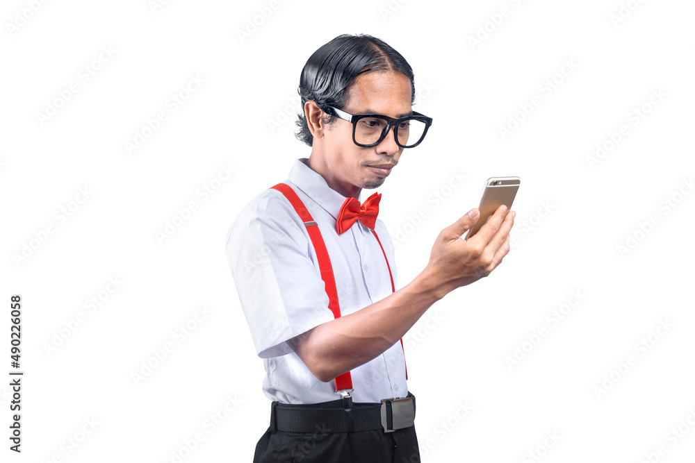 Asian nerd with an ugly face holding mobile phone Asian nerd with an ugly face holding mobile phone