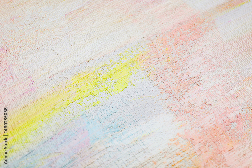 Strokes of different pastel acrylic paints on white canvas, closeup