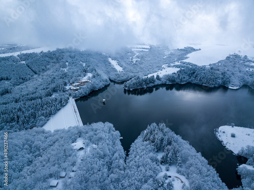 Beautiful view of a lake in Dushantsi and a snow-covered landscape photo