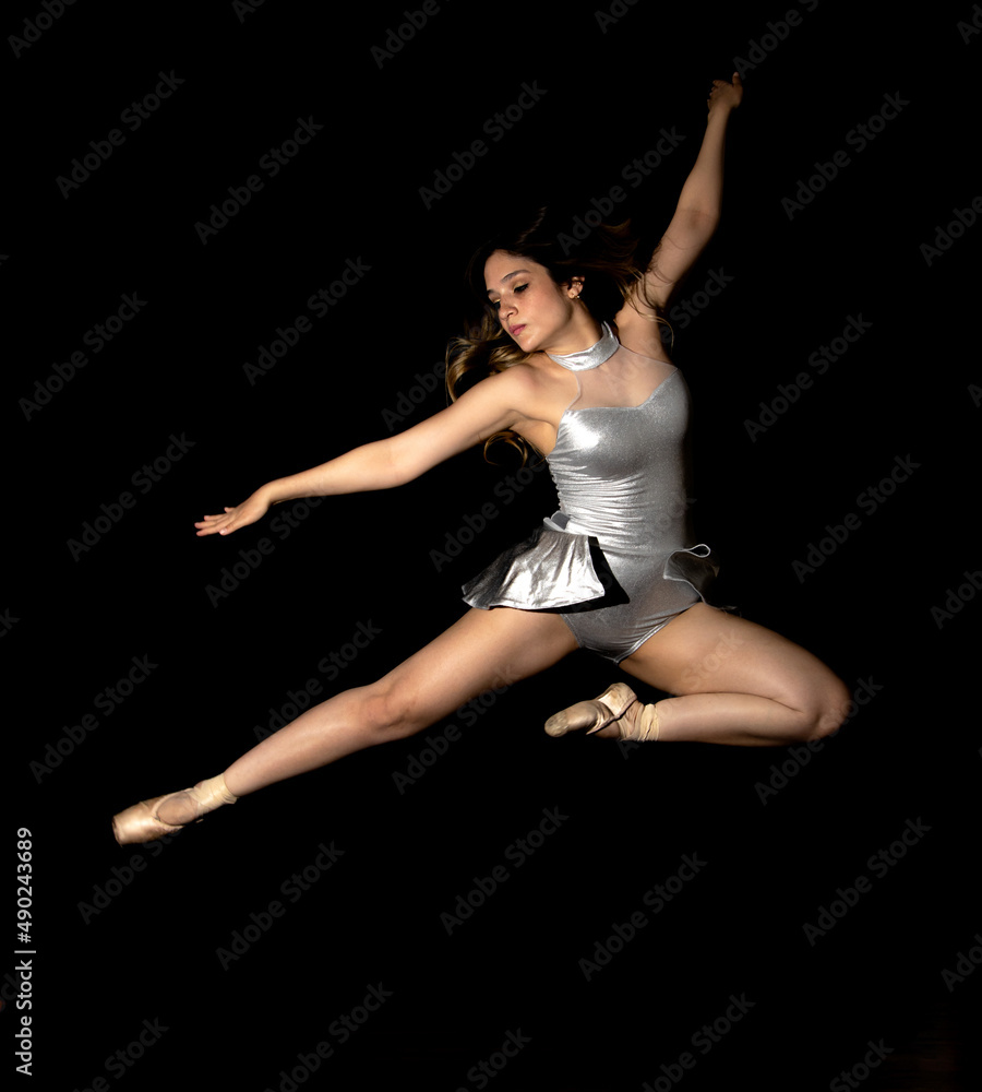 Young latin woman ballet model. with ballet shoes. exercising happy, smiling. with black background and copy space for advertising. low key photo. Young latin woman ballet model. with ballet shoes. exercising happy, smiling. with black background and copy space for advertising. low key photo.