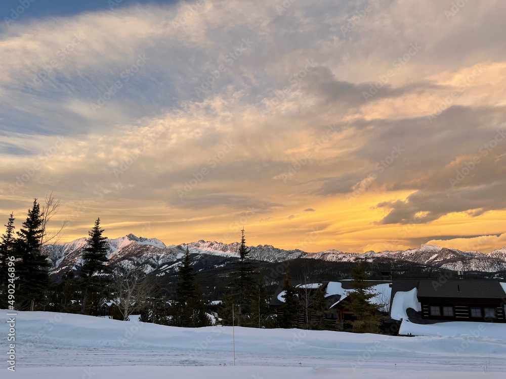 Golden sunset skies over Gallatin Peak as seen from Big Sky, Montana on a winter day Golden sunset skies over Gallatin Peak as seen from Big Sky, Montana on a winter day