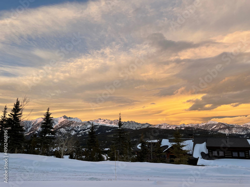 Golden sunset skies over Gallatin Peak as seen from Big Sky, Montana on a winter day