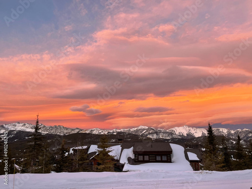 Dramatic and colourful sunset skies over Gallatin Peak as seen from Big Sky  Montana on a winter day