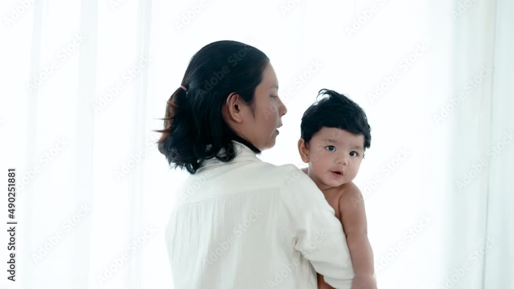 4K 50fps, Asian single mother holding a 2-month-old baby boy to comfort him after waking up. Concept Happy Family 4K 50fps, Asian single mother holding a 2-month-old baby boy to comfort him after waking up. Concept Happy Family