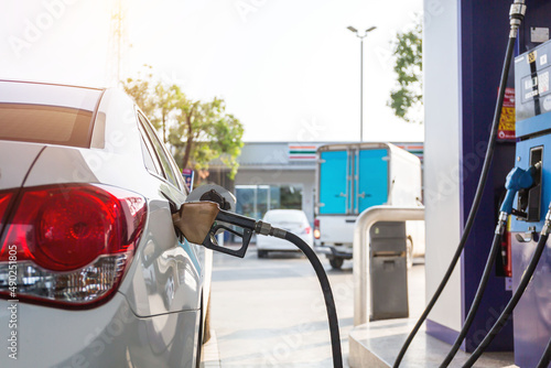 Pumping gasoline fuel in car at gas station.concept Travel,price oil,industrail business and transportation.. photo