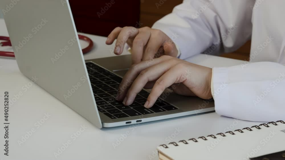 4K 50fps, Close-up of the doctor's hand typing information, patient history, illness into laptop to summarize the symptoms. 4K 50fps, Close-up of the doctor's hand typing information, patient history, illness into laptop to summarize the symptoms.