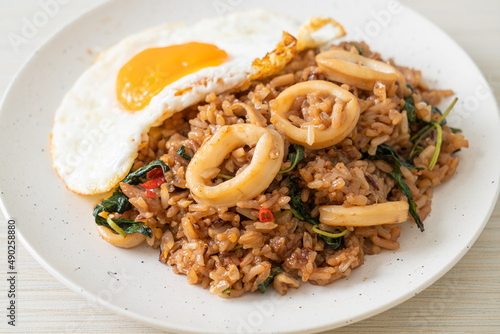 fried rice with squid and basil topped fried egg in Thai style