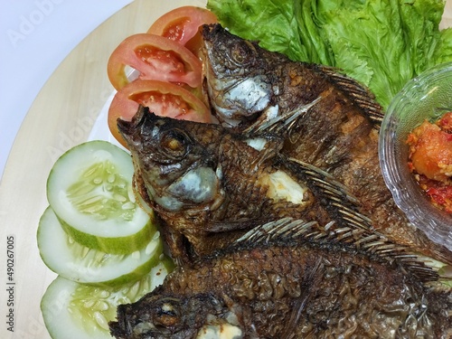 Fried Mujair Fish, fresh water fish, crispy savory photo