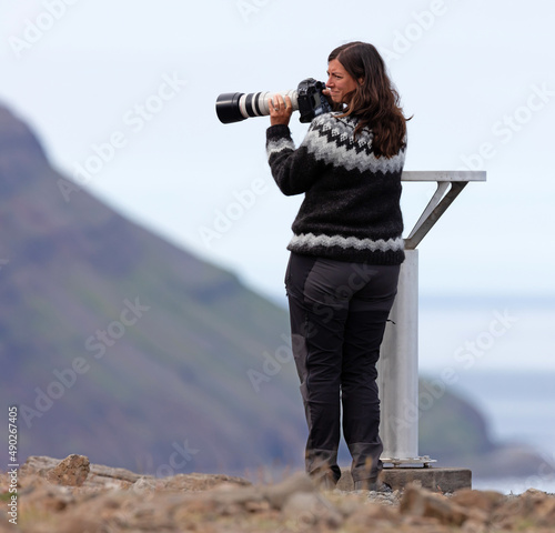 Woman in traditional Icelandic sweater enjoying the Icelandic landscape photo