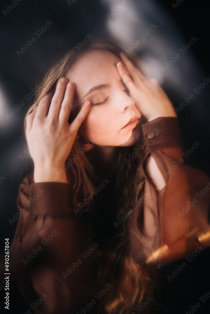 Surrealistic portrait of a girl of Slavic appearance with curly hair, close-up of her face, slight blurs and glare from lighting