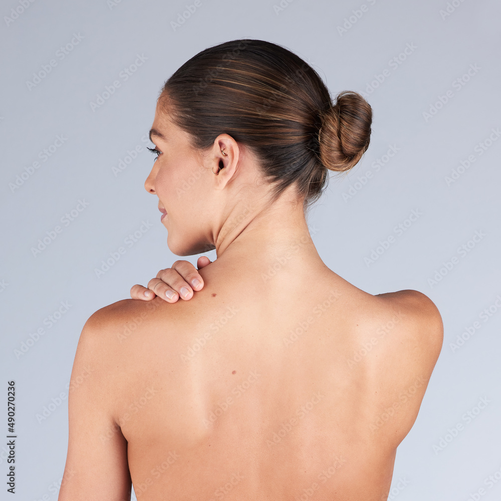 Obraz premium I cant stop feeling my smooth skin. Shot of a young woman standing alone in the studio and posing.