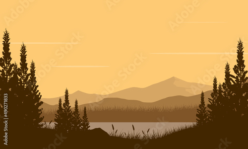 Amazing the view of the mountain view with pine tree silhouette from the riverside at dusk
