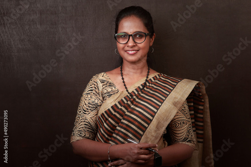 Portrait of a happy woman of Indian ethnicity wearing traditional dress sari photo