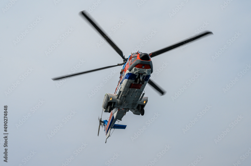 Fototapeta premium A helicopter flying in the sky.